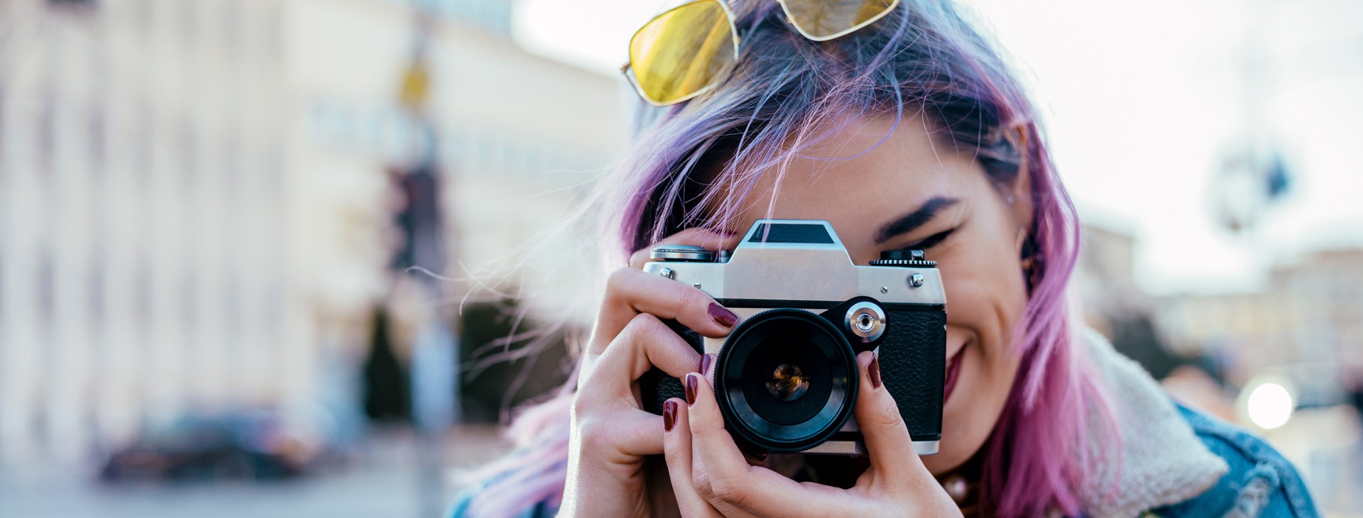 Close-up image of urban photographer using the camera