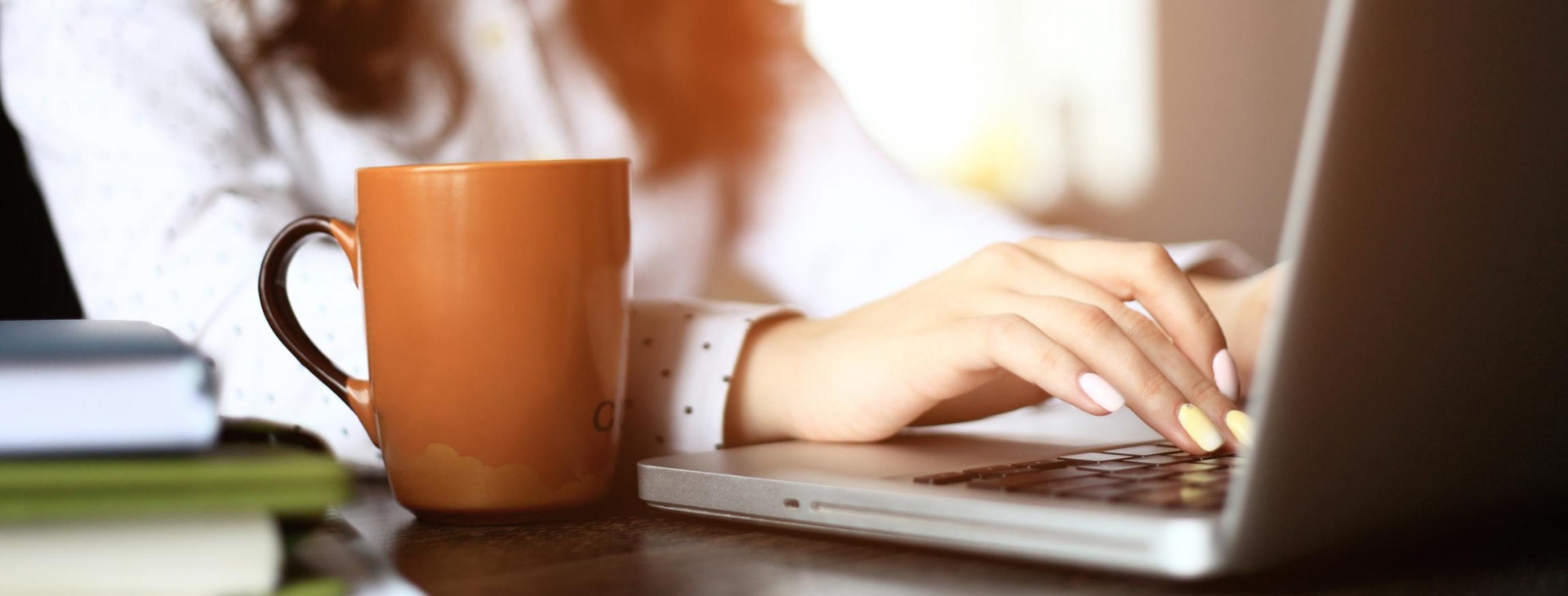 A woman types on a computer.