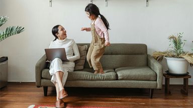 Une étudiante avec sa fille sur un canapé
